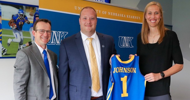UNK women’s basketball coaches Drew and Nicole Johnson are pictured with Athletic Director Marc Bauer, left, during an introductory press conference in May 2023. (UNK Communications)