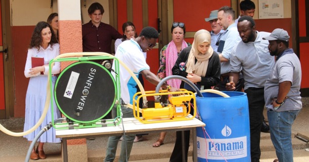  Husker representatives watch a demonstration of two kinds of solar-powered water pumps at the Don Bosco Solar and Renewable Energy Center in Ghana. They are (from left) Cheyenne Gerlach, assistant director, Yeutter Institute; Renata Rimšaitė, senior program manager, Water for Food; Matthew Gillespie and Lexi Bodlak, student fellows; Hugues Dossou Espoir, Don Bosco employee; Erin Anders, senior program manager, Water for Food; Zanib Al Razaq, student fellow; Jude Cobbing, senior program manager, Water for Food; Nick Brozović, director of policy, Water for Food; Ethan Zen, student fellow; Emmanuel Tamba Sesay, Don Bosco employee; and Lewis Adjei-Banin, tour guide. (David K. Bakayona/Don Bosco)